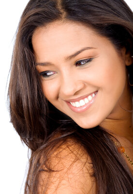 woman looking over shoulder smiling bright white teeth, Cedar City, UT cosmetic dentistry
